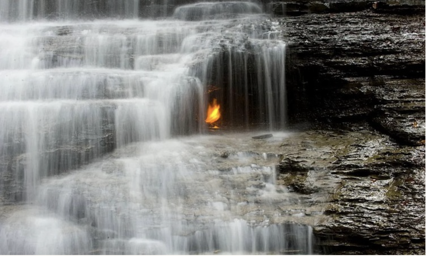 Ngọn lửa vĩnh cửu cháy phía sau thác nước. 