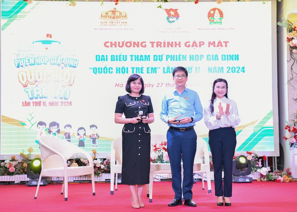 Chị Nguyễn Phạm Duy Trang trao quà lưu niệm ông Nguyễn Thành Trung và bà Thái Quỳnh Mai Dung.