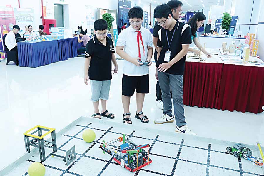 Các bạn thiếu nhi say sưa với mô hình robot.