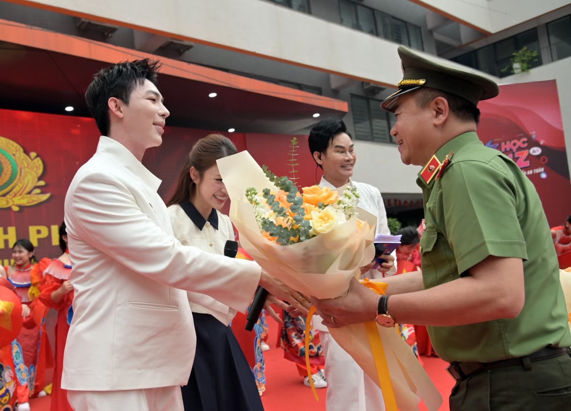 Trung tướng Nguyễn Thanh T&ugrave;ng, Gi&aacute;m đốc CATP tặng hoa cảm ơn c&aacute;c nghệ sỹ tham gia chương tr&igrave;nh.